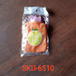 Orange hot water bag with cover for relief and warmth